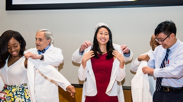 new medical students don white coats