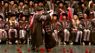 A graduate getting their hood.