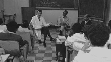 old photo of a doctor leading a class discussion