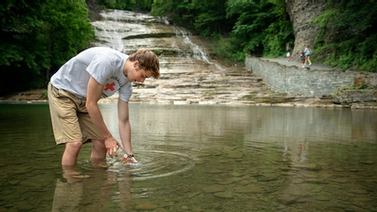 member of Ruth Richarson's lab takes a water sample
